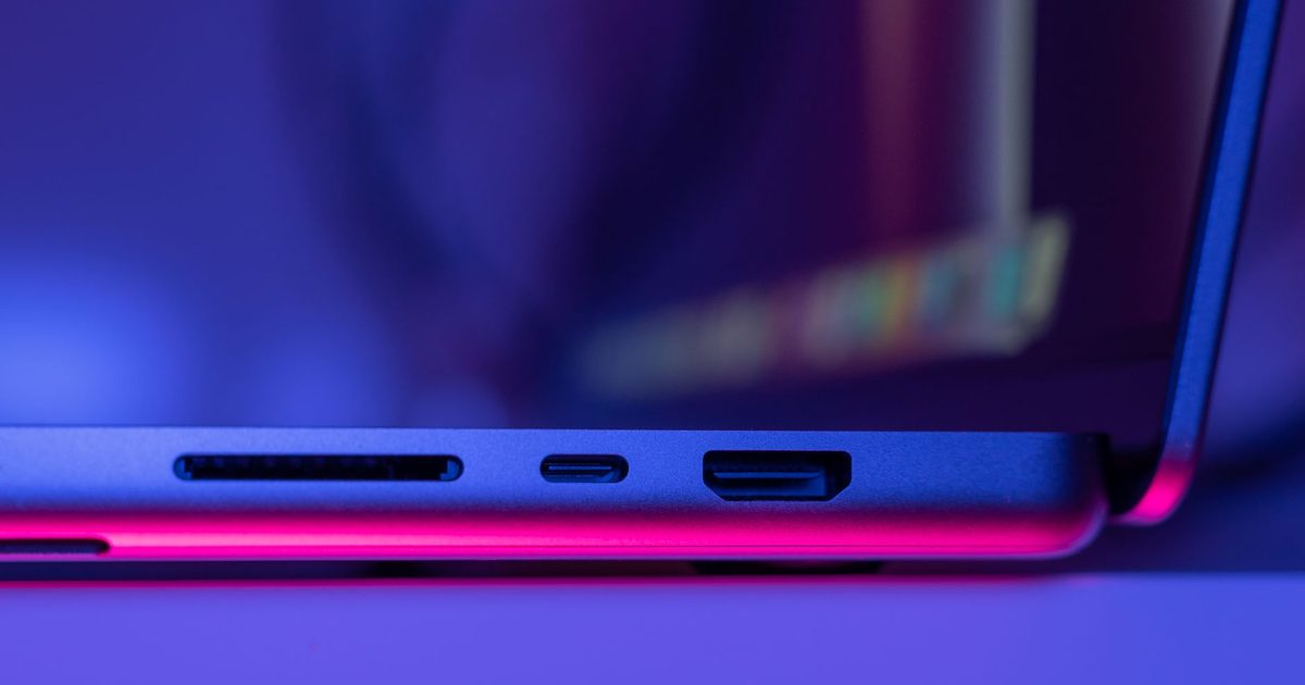 The USB-C, HDMI and card-reader ports on the side of a laptop
